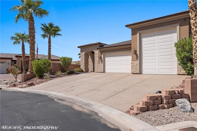 653 Paloma Cir, Mesquite, NV 89027 - prairie-style house with driveway, stucco siding, a garage, and stone siding