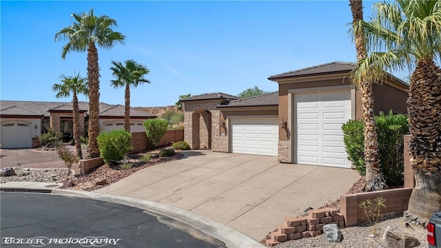 653 Paloma Cir, Mesquite, NV 89027 - view of front of home with concrete driveway, an attached garage, and stucco siding