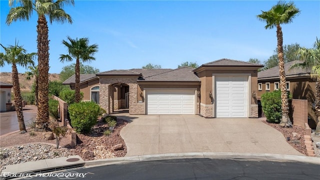 653 Paloma Cir, Mesquite, NV 89027 - view of front of home featuring stone siding, concrete driveway, stucco siding, and an attached garage