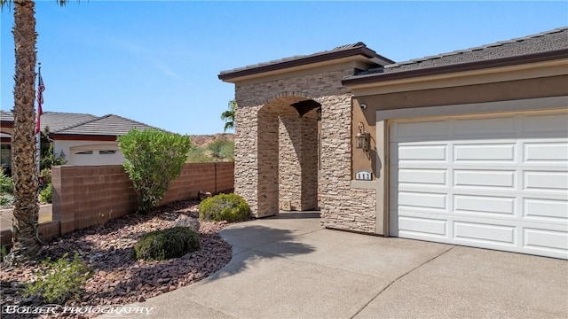 653 Paloma Cir, Mesquite, NV 89027 - exterior space featuring stone siding, stucco siding, driveway, and fence