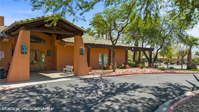 653 Paloma Cir, Mesquite, NV 89027 - exterior space with a tiled roof, stucco siding, and a patio area