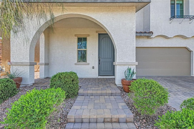 632 Cadence Vista Dr, Henderson, NV 89011 - doorway to property with stucco siding, a garage, and driveway