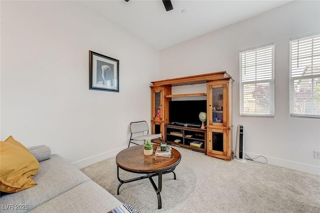 living area with baseboards, carpet flooring, and ceiling fan