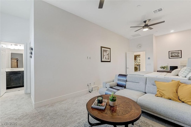 interior space with baseboards, light carpet, washer / dryer, and visible vents