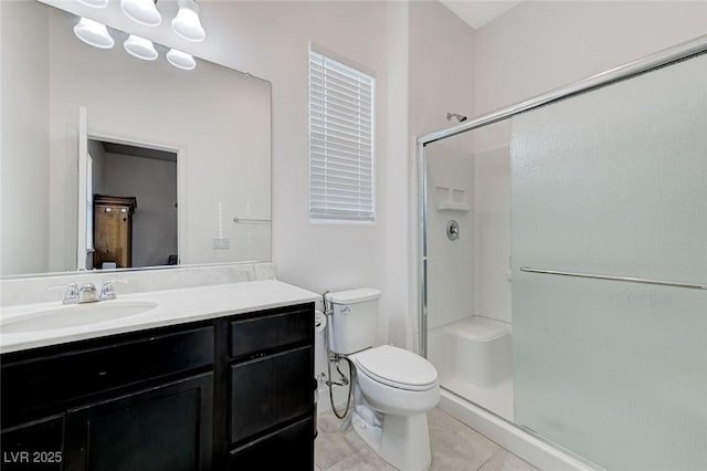 bathroom with a stall shower, tile patterned flooring, toilet, and vanity