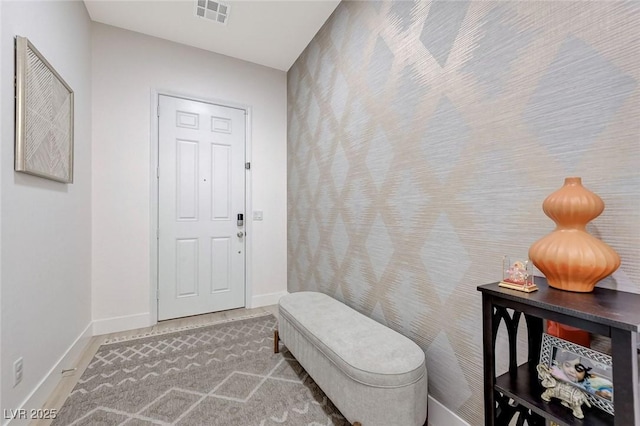 interior space featuring baseboards and visible vents