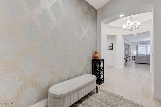 hall featuring baseboards, recessed lighting, a chandelier, and light wood-type flooring