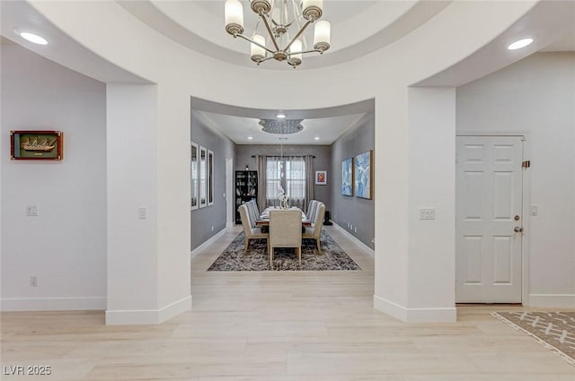 dining room with light wood finished floors, an inviting chandelier, baseboards, and recessed lighting