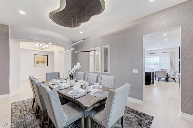 dining area with recessed lighting and wood finished floors