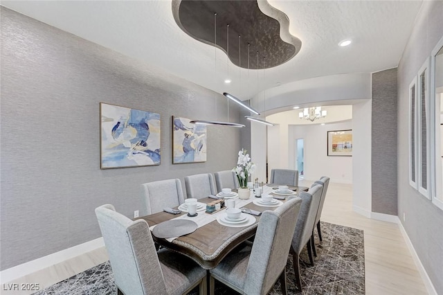 dining area featuring baseboards, a notable chandelier, recessed lighting, and wood finished floors
