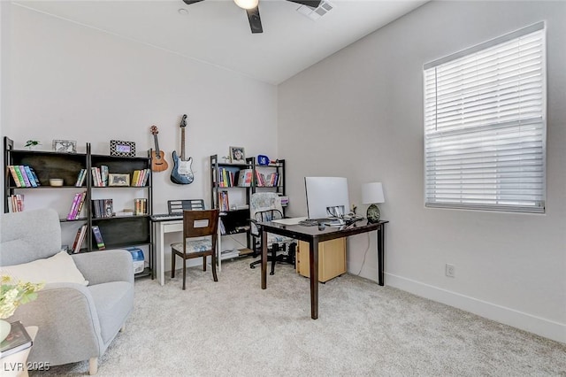 carpeted home office with ceiling fan, baseboards, and visible vents