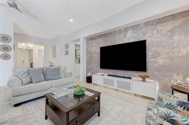 living room featuring light wood finished floors and a chandelier