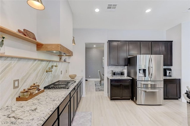 kitchen featuring tasteful backsplash, open shelves, visible vents, light wood-style flooring, and appliances with stainless steel finishes