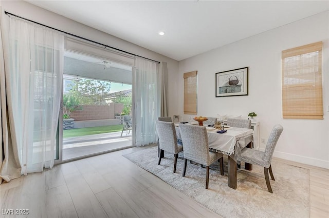 dining room with baseboards, recessed lighting, and wood finished floors