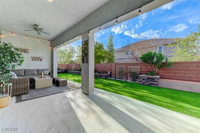 view of patio / terrace with ceiling fan, a fenced backyard, and an outdoor living space
