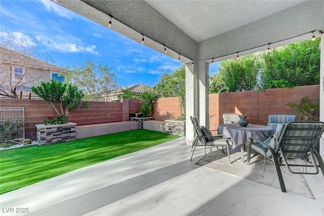 view of patio / terrace with outdoor dining space and a fenced backyard