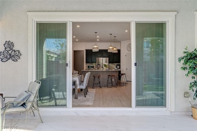 entrance to property with stucco siding