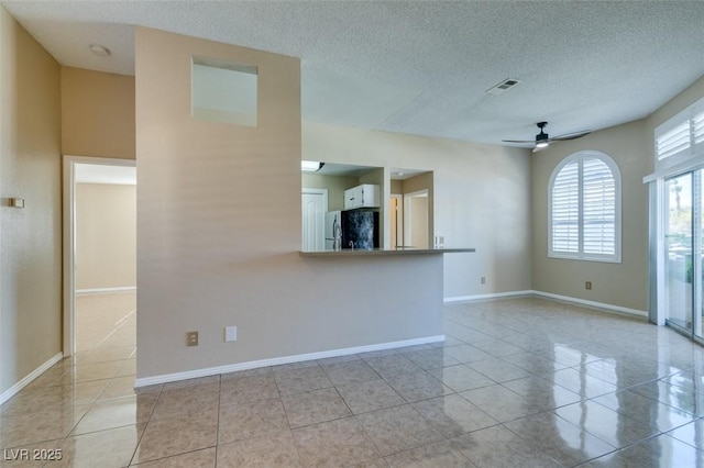 3150 Soft Breezes Dr Unit 2030, Las Vegas, NV 89128 - unfurnished room with light tile patterned floors, visible vents, ceiling fan, and a textured ceiling
