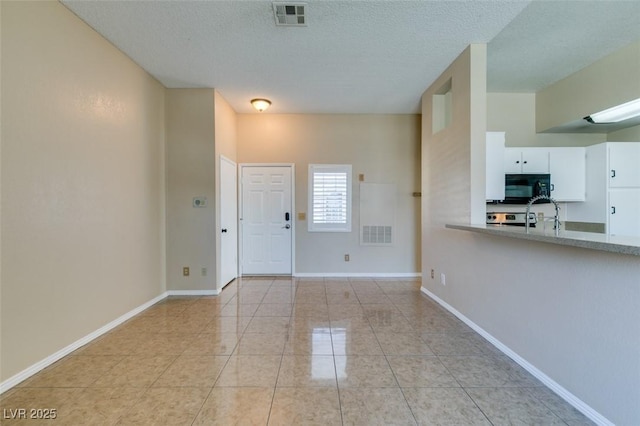 3150 Soft Breezes Dr Unit 2030, Las Vegas, NV 89128 - interior space featuring baseboards, light tile patterned flooring, visible vents, and a textured ceiling
