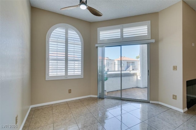 3150 Soft Breezes Dr Unit 2030, Las Vegas, NV 89128 - tiled spare room with ceiling fan, a textured ceiling, and baseboards