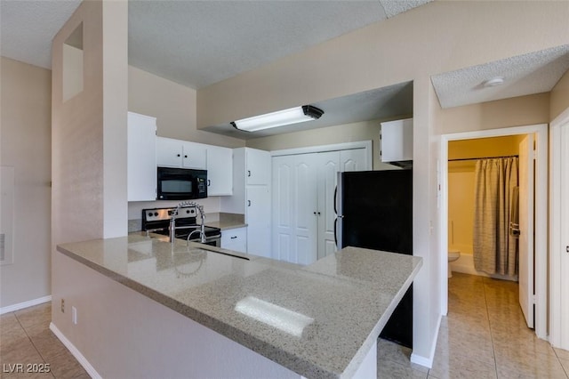 3150 Soft Breezes Dr Unit 2030, Las Vegas, NV 89128 - kitchen featuring a peninsula, light tile patterned floors, light stone countertops, and black appliances