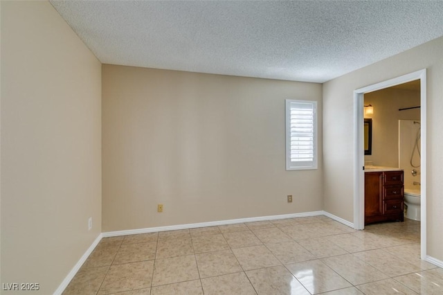 3150 Soft Breezes Dr Unit 2030, Las Vegas, NV 89128 - unfurnished room with a textured ceiling, baseboards, and light tile patterned floors