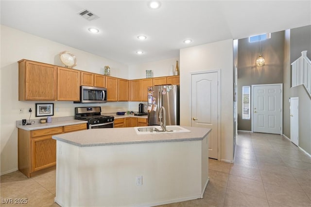 kitchen featuring a sink, visible vents, light countertops, light tile patterned floors, and appliances with stainless steel finishes