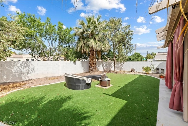view of yard with a fire pit and a fenced backyard