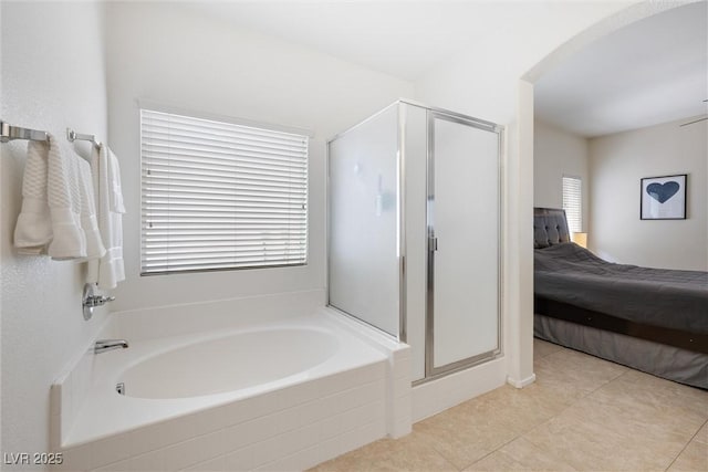 bathroom with a shower stall, tile patterned floors, ensuite bath, and a garden tub