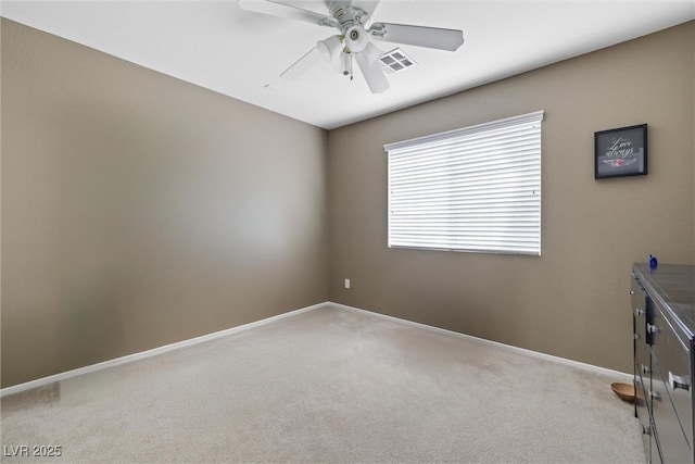 unfurnished room featuring ceiling fan, light carpet, baseboards, and visible vents