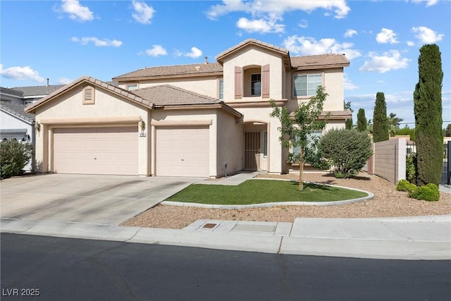 mediterranean / spanish home featuring driveway, fence, a garage, stucco siding, and a tile roof