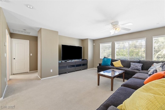 living room with light colored carpet, a ceiling fan, and a healthy amount of sunlight