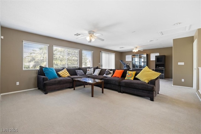 living area with light colored carpet, attic access, visible vents, and a ceiling fan