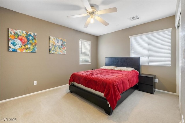 bedroom with baseboards, ceiling fan, visible vents, and carpet