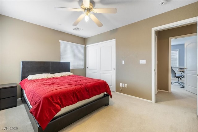 bedroom with a ceiling fan, a closet, baseboards, visible vents, and light colored carpet