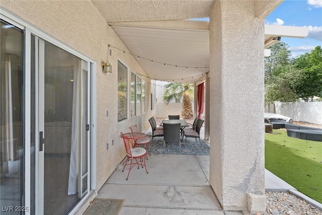 view of patio featuring fence and outdoor dining space