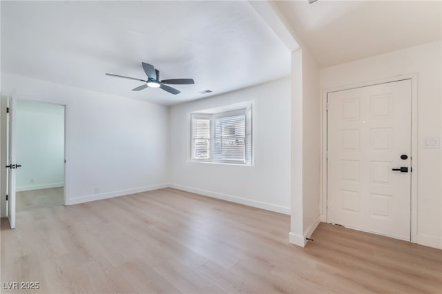 interior space featuring a ceiling fan, baseboards, light wood-style flooring, and visible vents