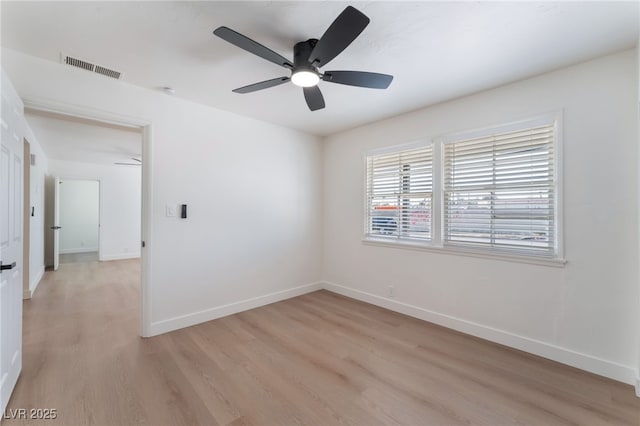 unfurnished room with light wood-type flooring, visible vents, baseboards, and a ceiling fan