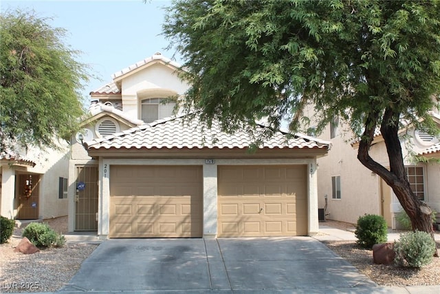 mediterranean / spanish-style home featuring concrete driveway, stucco siding, a tile roof, and a garage