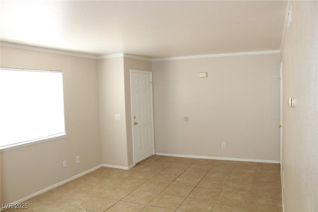 unfurnished room featuring crown molding, light tile patterned floors, and baseboards