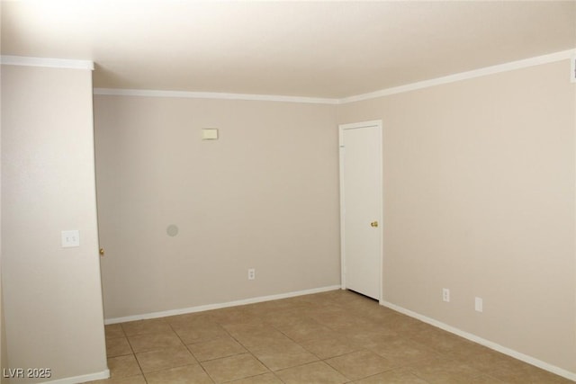 empty room with light tile patterned flooring, baseboards, and ornamental molding