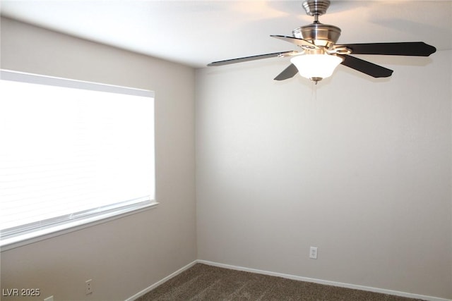 unfurnished room featuring dark colored carpet, ceiling fan, and baseboards