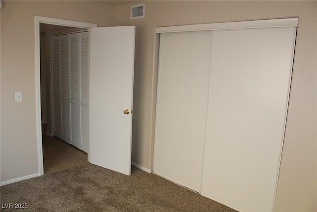 unfurnished bedroom featuring carpet and baseboards