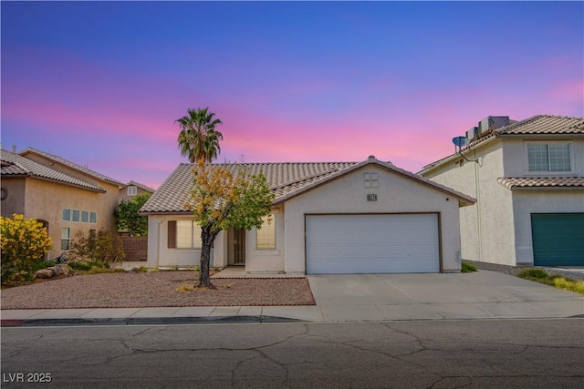 6274 Elderberry Wine Ave, Las Vegas, NV 89142 - mediterranean / spanish-style house featuring a tile roof, concrete driveway, an attached garage, and stucco siding