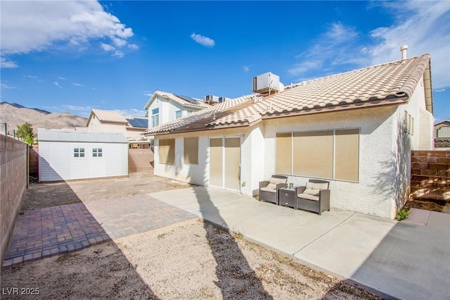 6274 Elderberry Wine Ave, Las Vegas, NV 89142 - rear view of house featuring a tile roof, a patio area, stucco siding, and an outbuilding