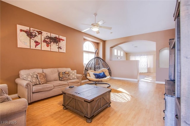 6274 Elderberry Wine Ave, Las Vegas, NV 89142 - living area with arched walkways, a ceiling fan, plenty of natural light, and light wood-style floors