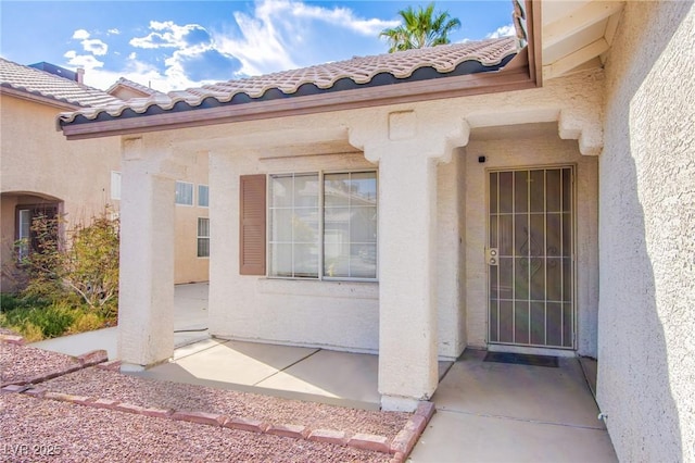 6274 Elderberry Wine Ave, Las Vegas, NV 89142 - property entrance with a patio area, stucco siding, and a tile roof