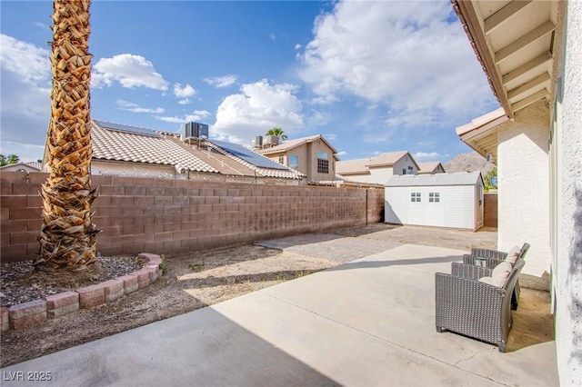 6274 Elderberry Wine Ave, Las Vegas, NV 89142 - view of patio with an outdoor structure, a residential view, a fenced backyard, and a shed