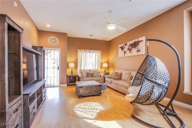 6274 Elderberry Wine Ave, Las Vegas, NV 89142 - living room with baseboards, ceiling fan, visible vents, and light wood-type flooring