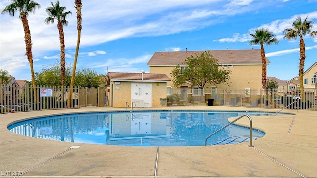 community pool with fence and a residential view
